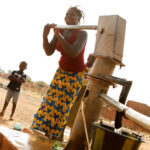 woman working the water pump